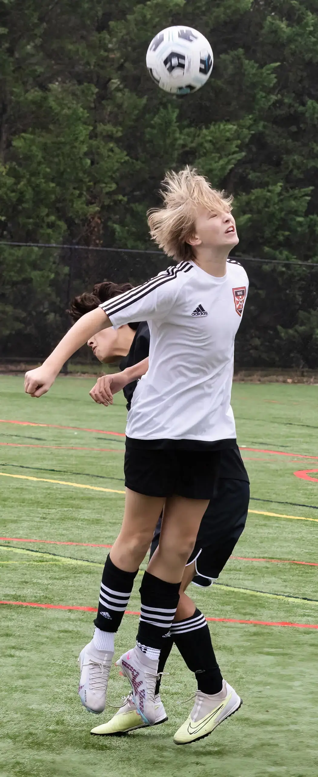 boy heading a soccer ball