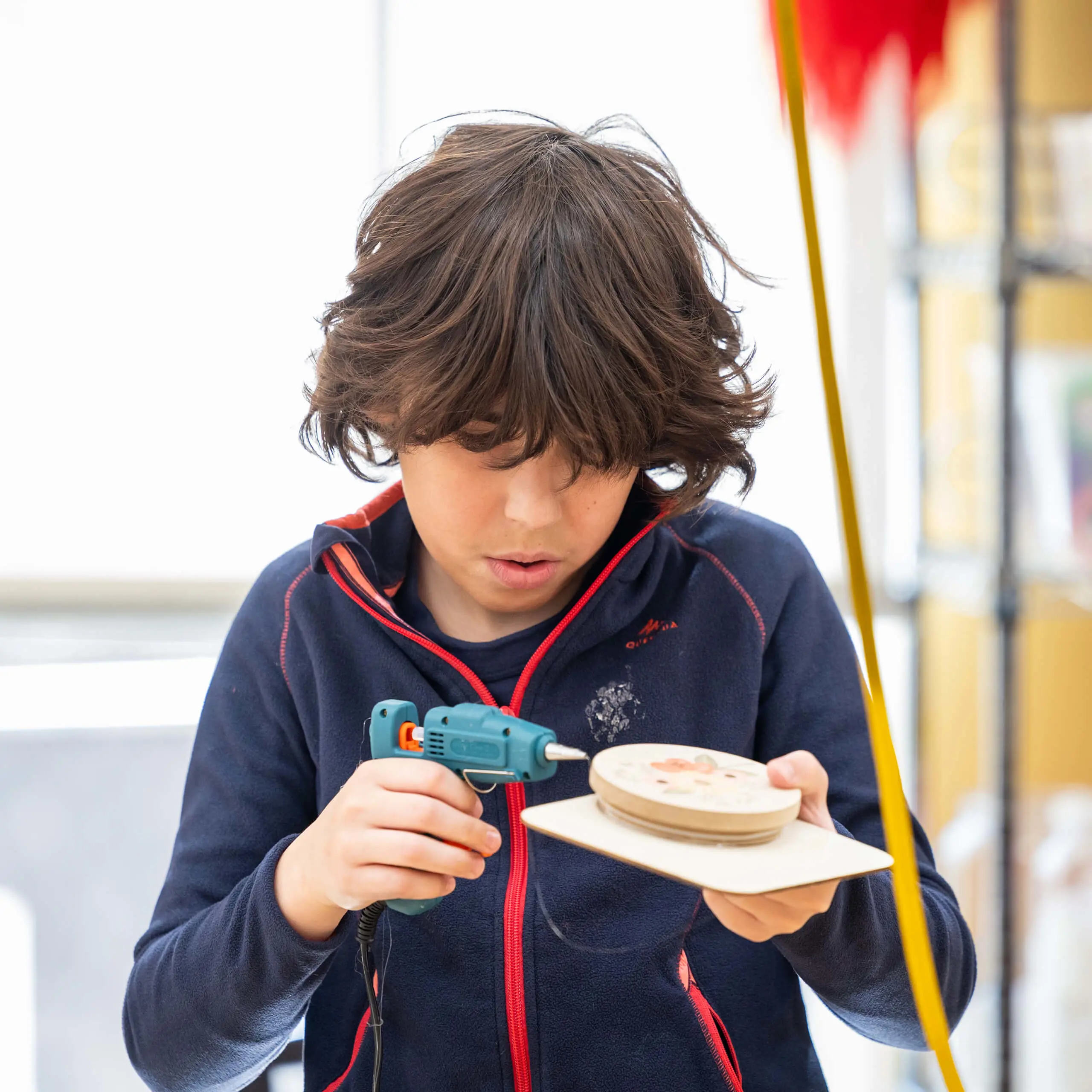 student working with a glue gun