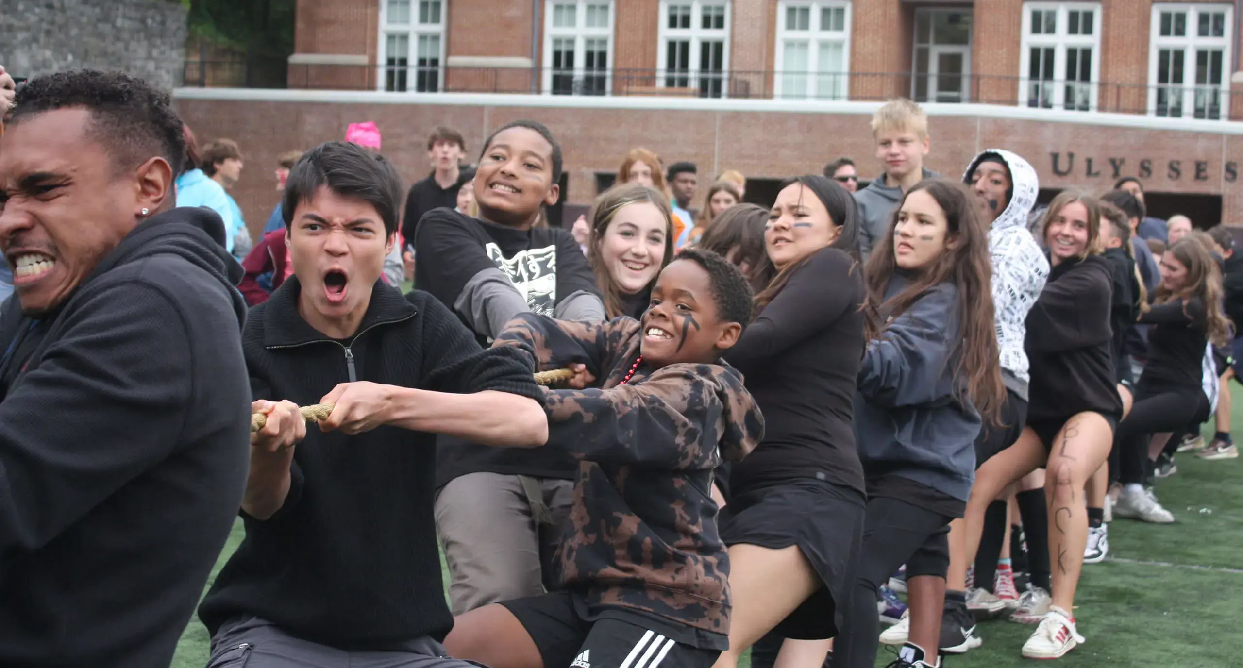 large group of students engaged in tug of war