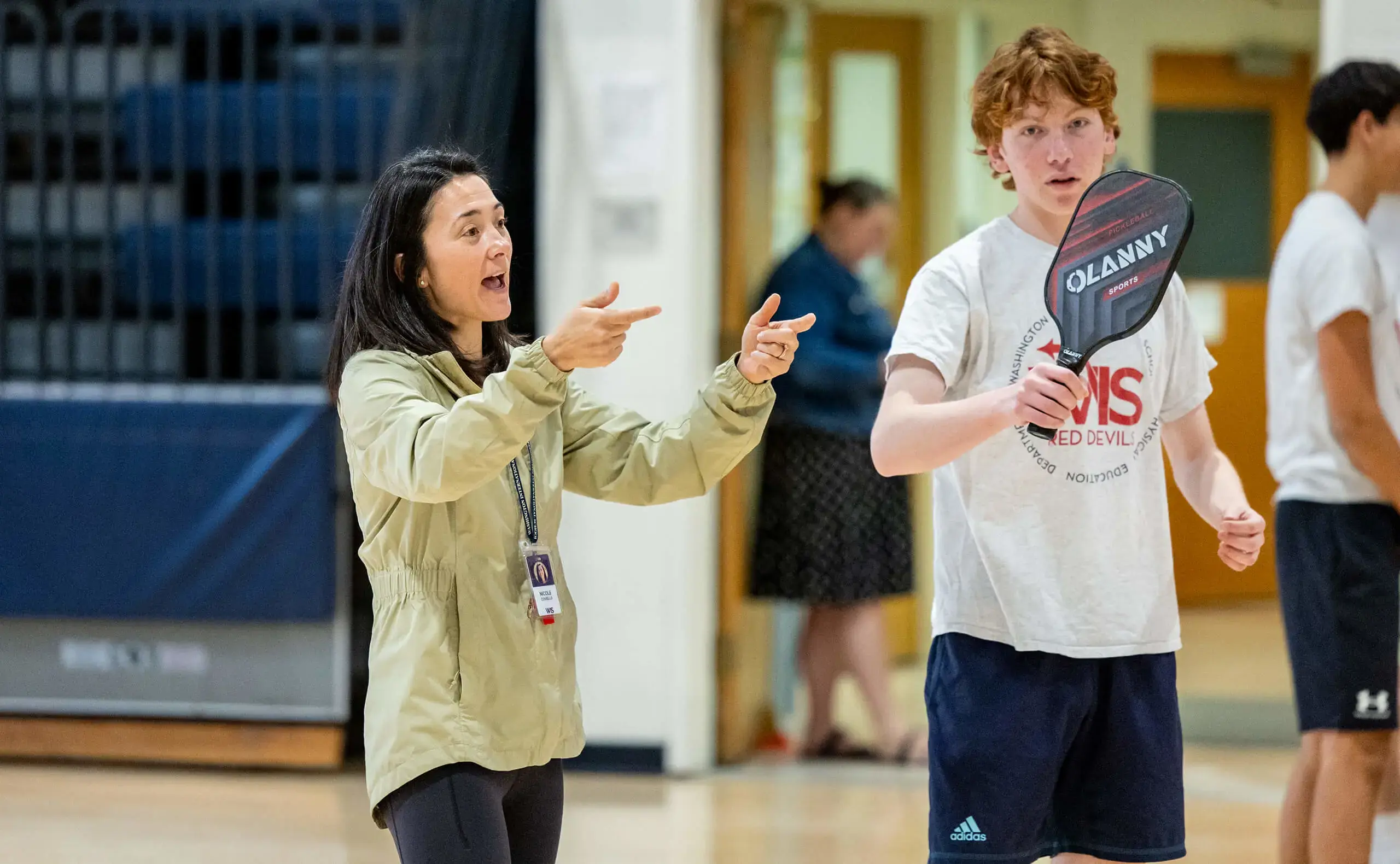 Table tennis coach instructing students