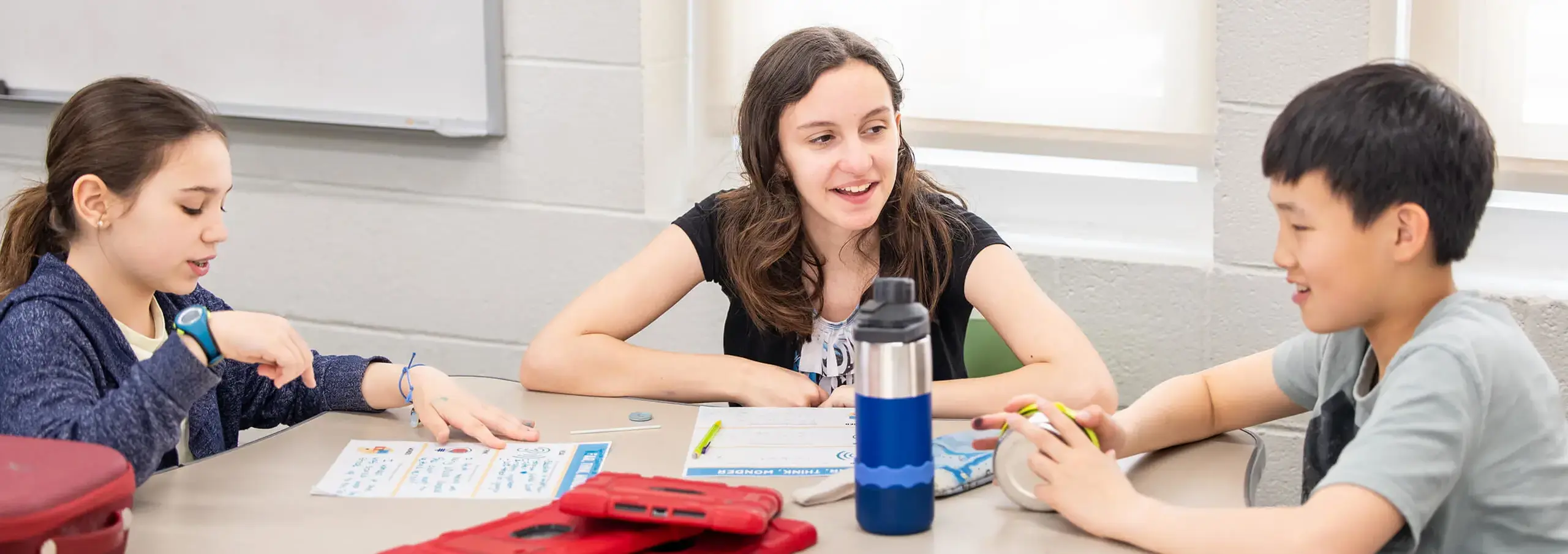 three students engaged in a discussion