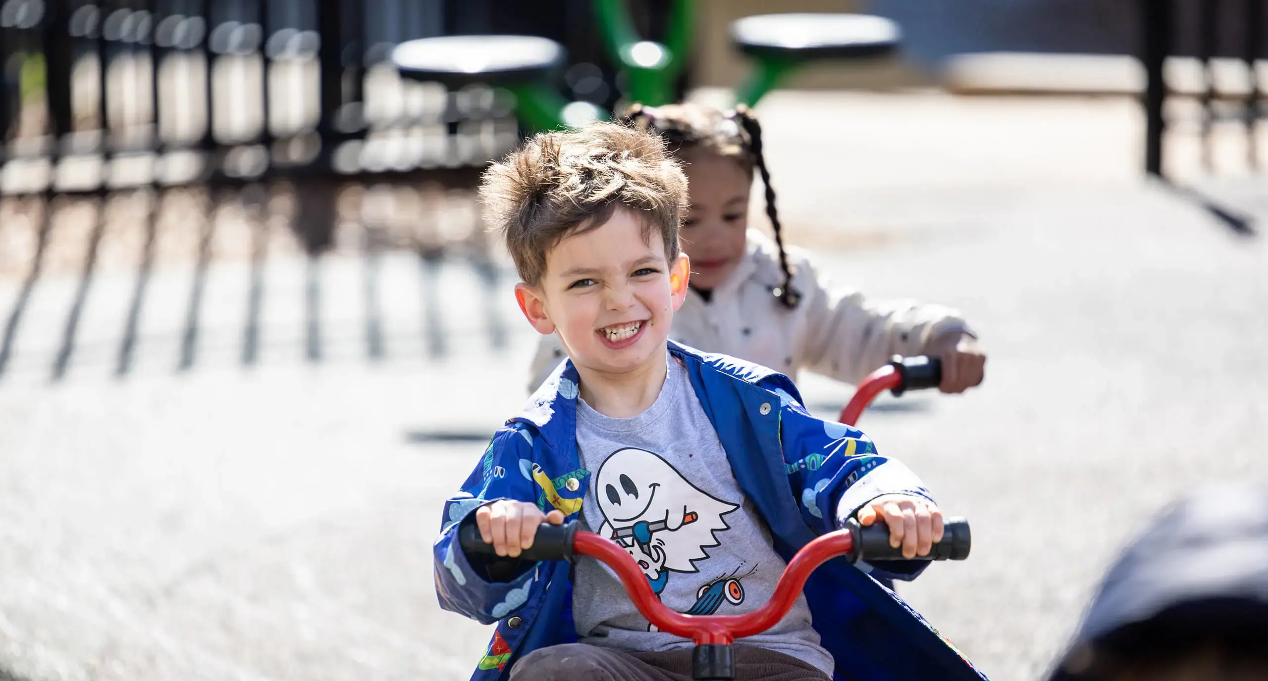 boy and girl riding tricycles