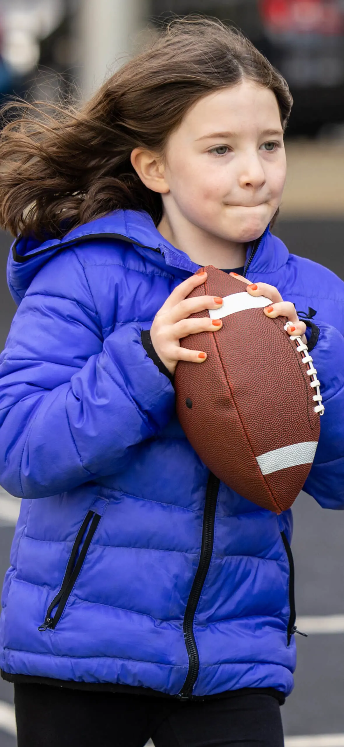 Girl running with rugby ball