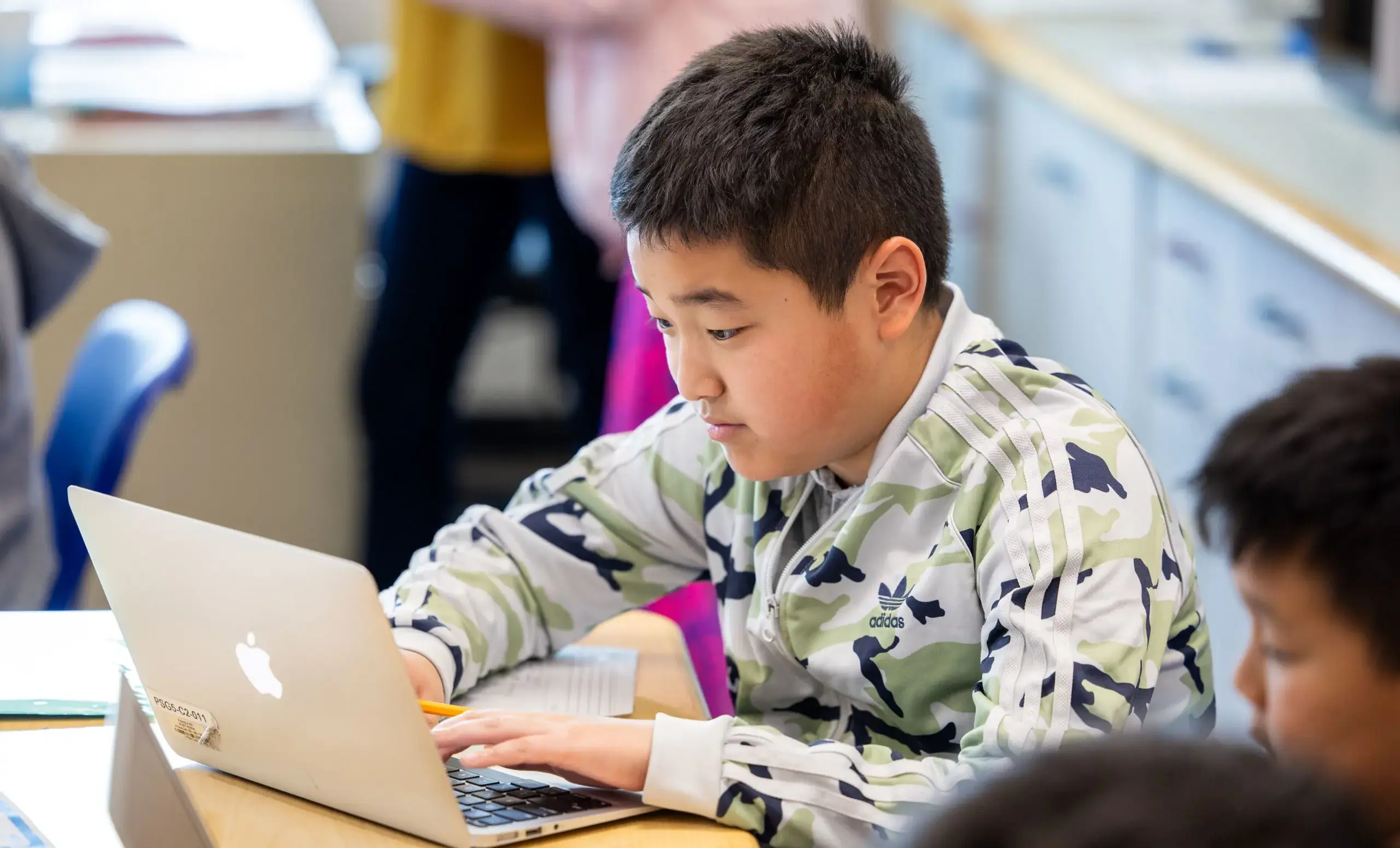 boy working on laptop computer