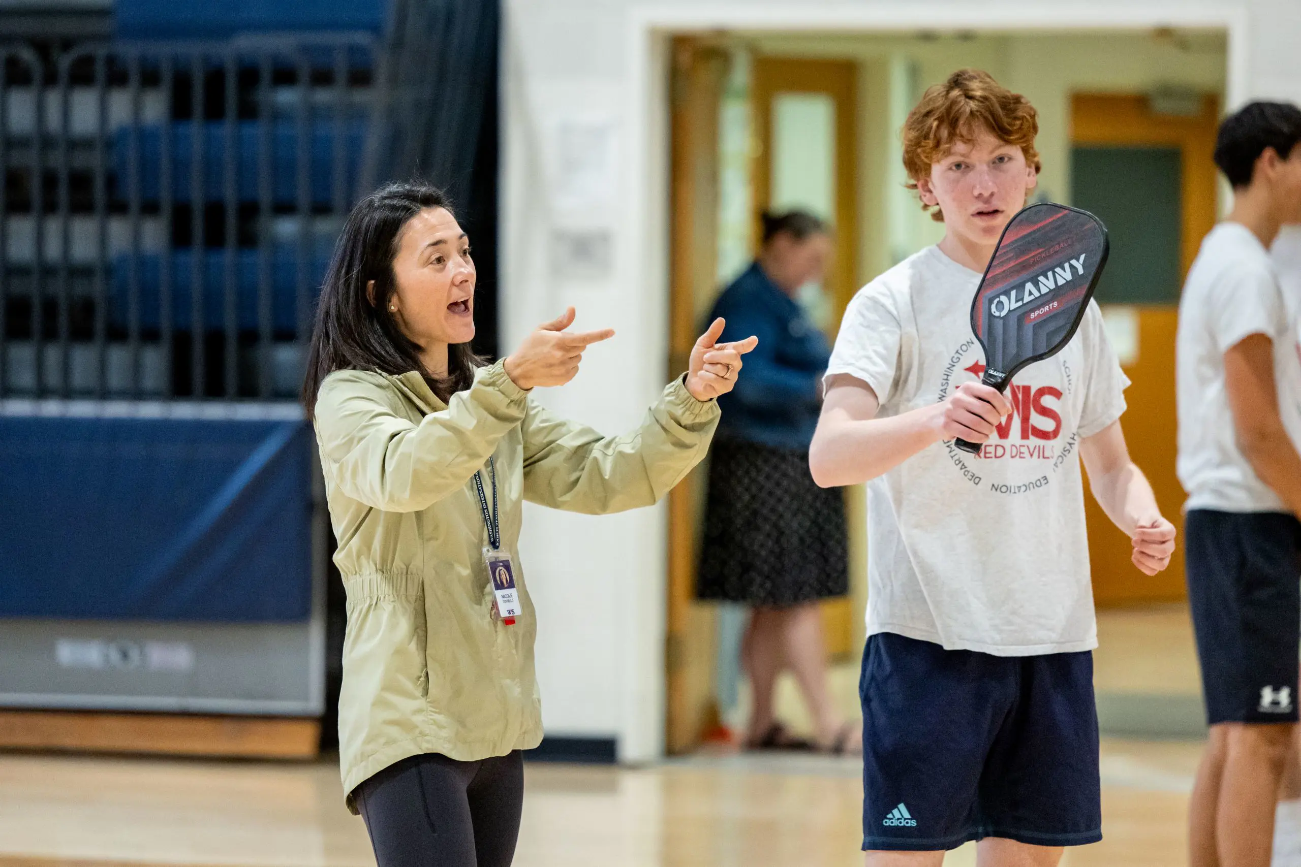 Coach instructing students