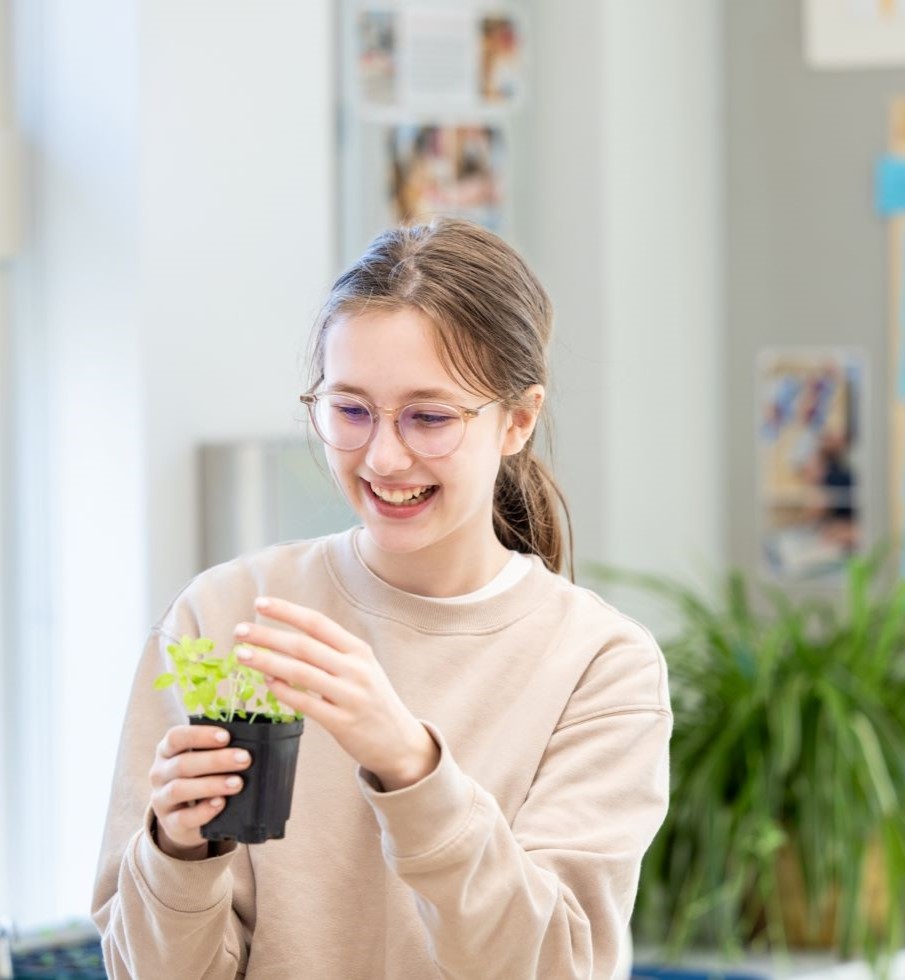 Girl holding a potted plant