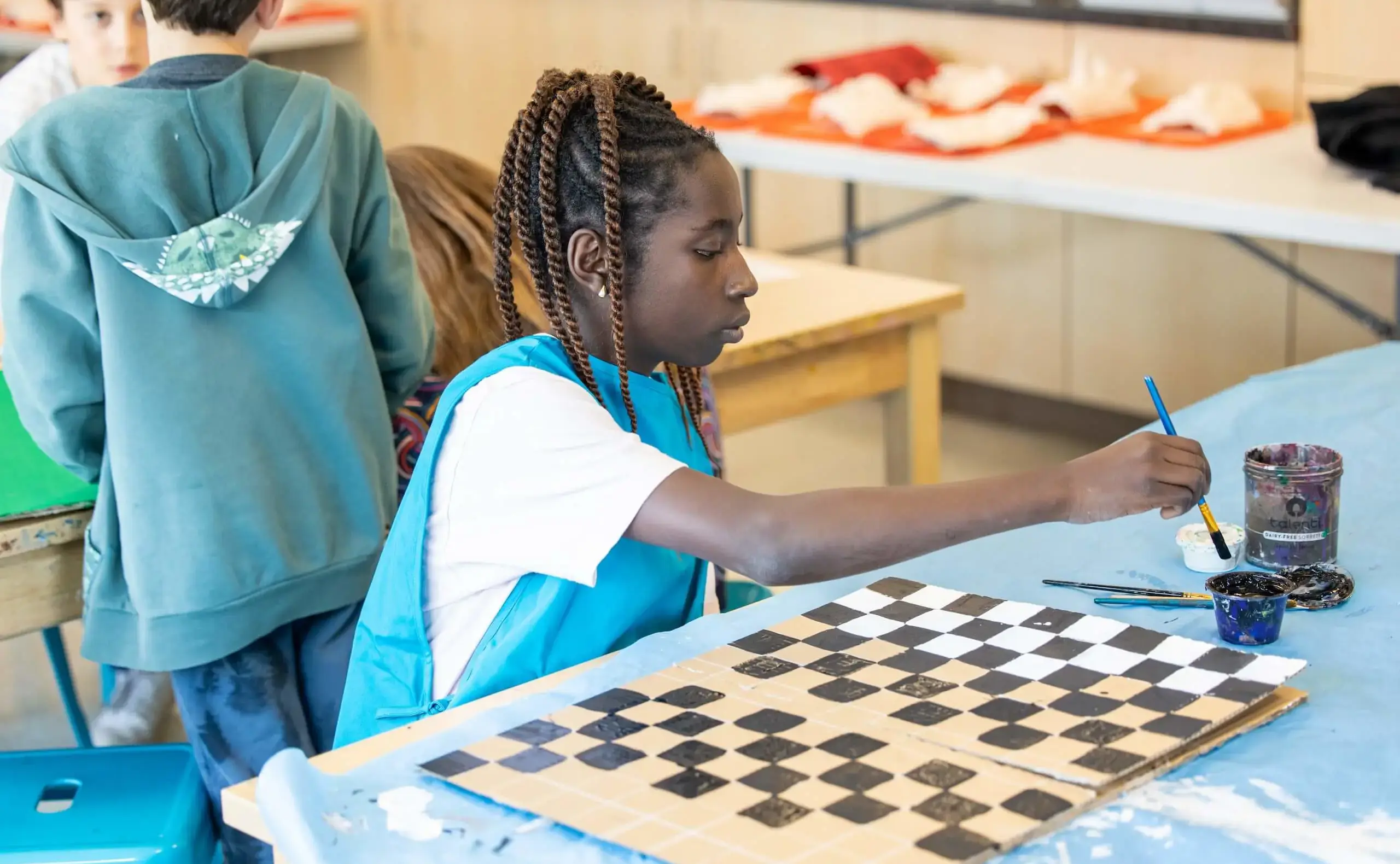 Student painting checkers board