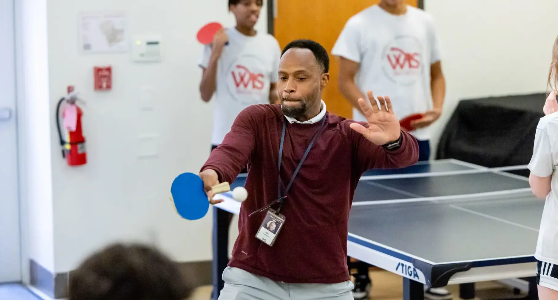 Teacher playing table tennis