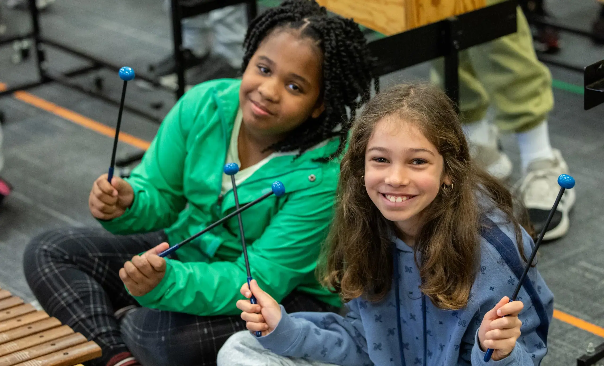 Two girls in front of xylophone